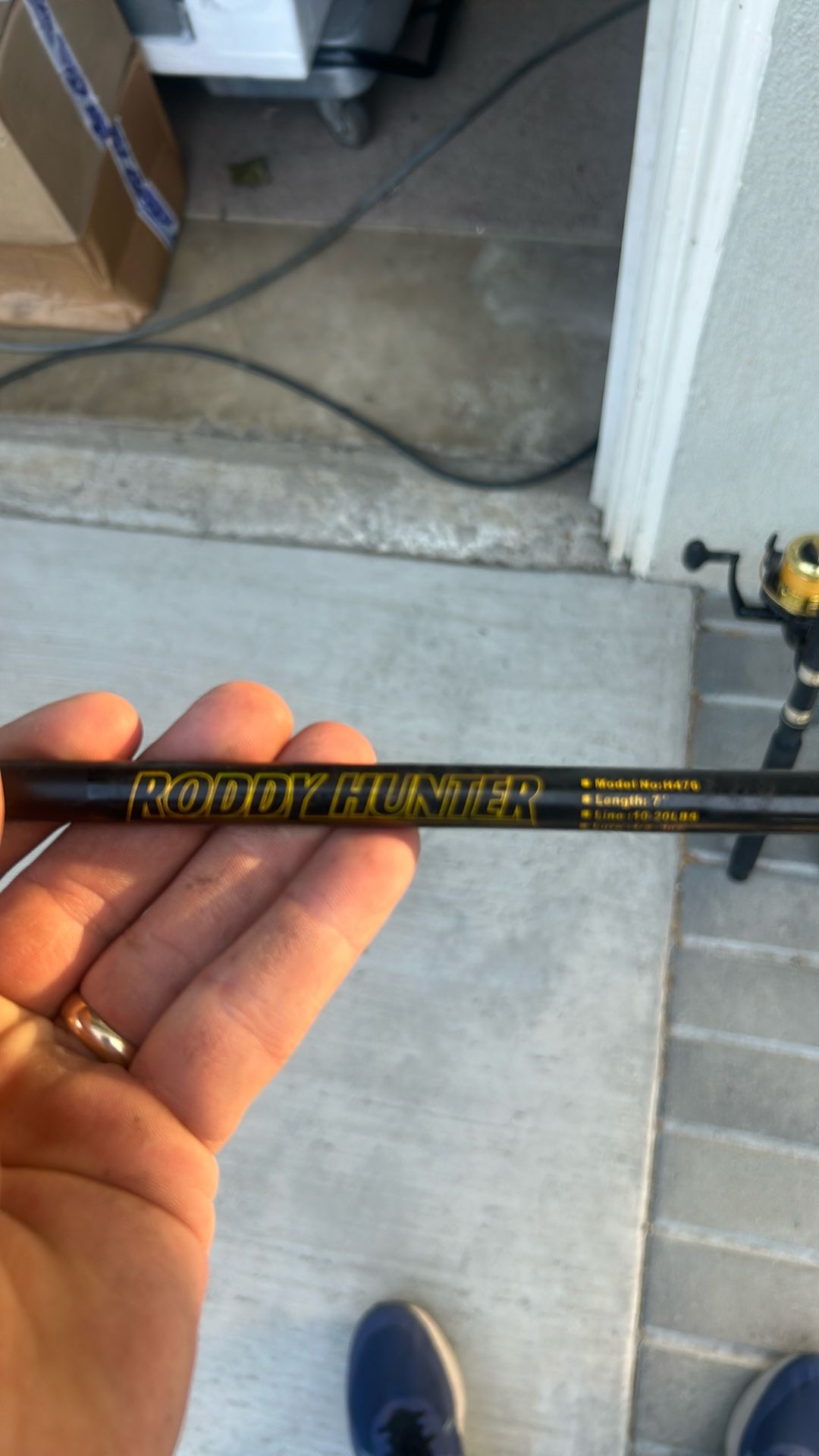 Two fishing poles and one reel.
