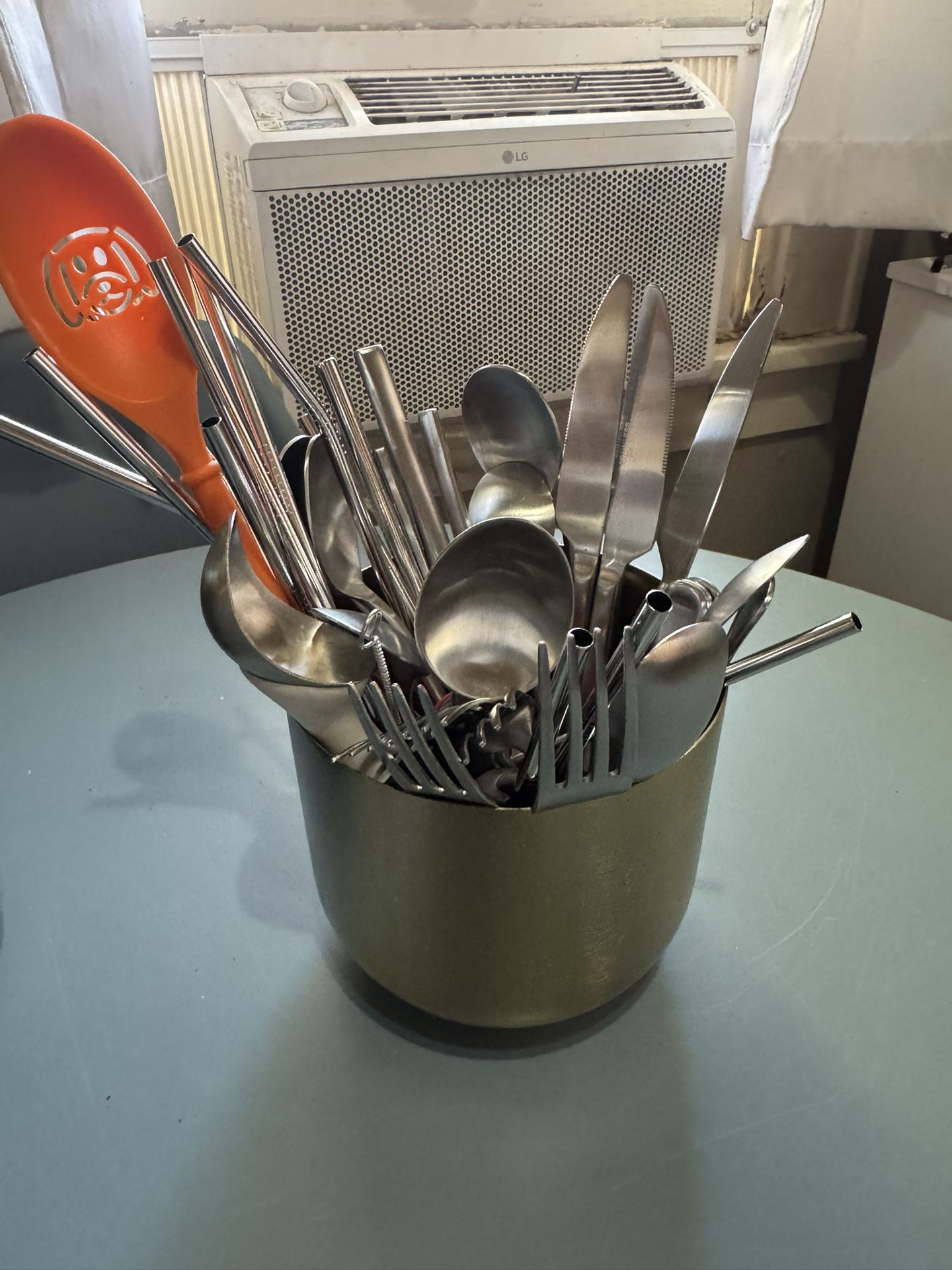 Silver Utensil Holder Full Of Utensils