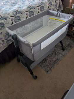 Baby bedside bassinet with wheels.