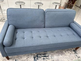 70” Long Blue Chesterfield Modern MCM Style Tufted Fabric Sofa Couch In Great Condition. Brown Wooden Legs. Includes 2 Blue Pillow Rolls With Zippers