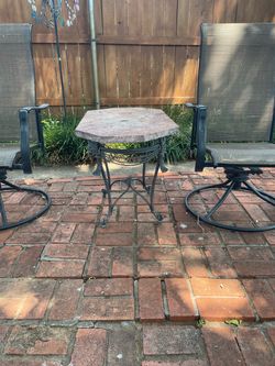 Outdoor table with 6 chairs, umbrella with stand and a side table.