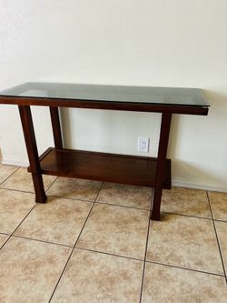 Glass table 31 inches tall  4 ft long  17 inches wide