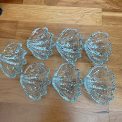 7 Vintage clear glass bowls are designed in the shape of clam or scallop shells