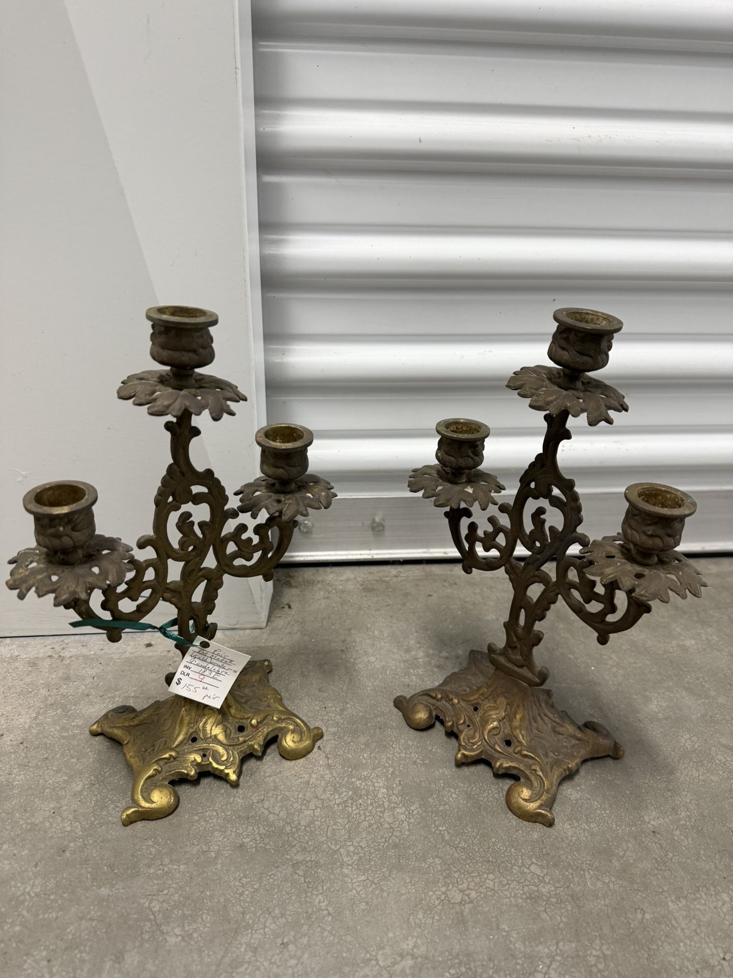 A pair of vintage ornate brass three-light candelabra.