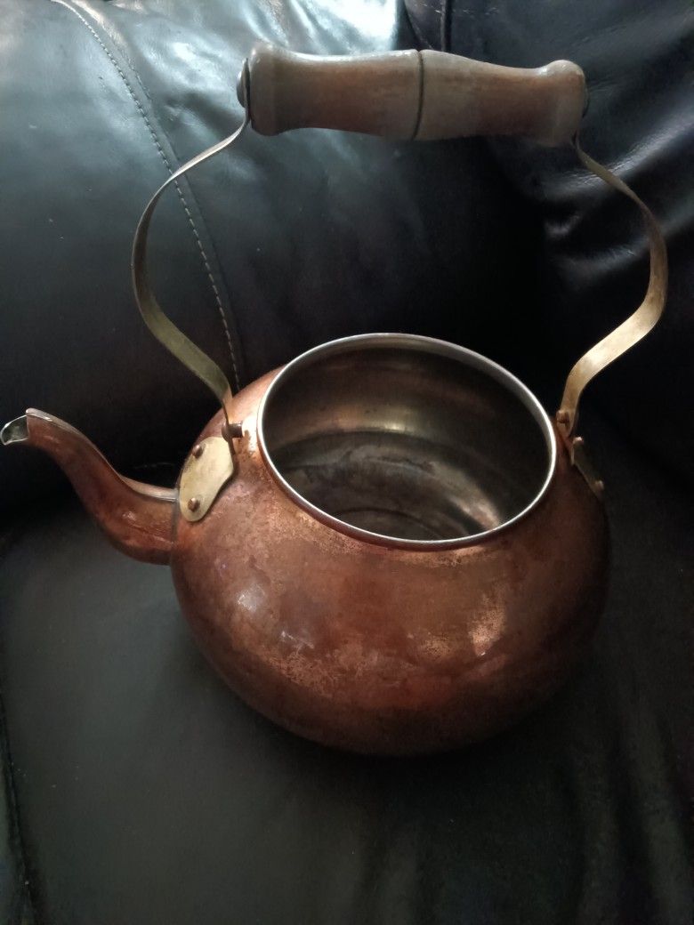 Antique copper kettle. Copper kettle with wooden handle 