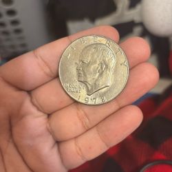 This is a 1978 Eisenhower dollar coin, the last large-size U.S. dollar coin series issued for circulation, honoring President Dwight D. Eisenhower. 