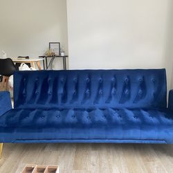 Blue futon with god accent legs