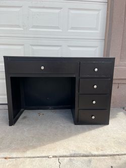 Woman’s vanity + vanity mirror with storage behind it.