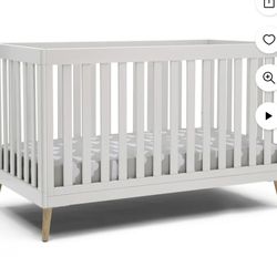 Delta Children Essex 4-in-1 Convertible Baby Crib, Bianca White with Natural Legs