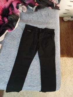 FRIED-DENIM brand label stitched onto the inside waistband of a pair of black slim-fit pants.