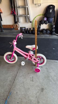 Girls bike with training wheels.