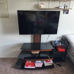 Black Glass Entertainment Center And A Vizio TV 