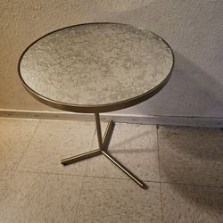 Mesa redonda de metal y espejo