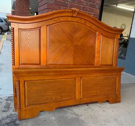 Queen size wooden bed with metal rails