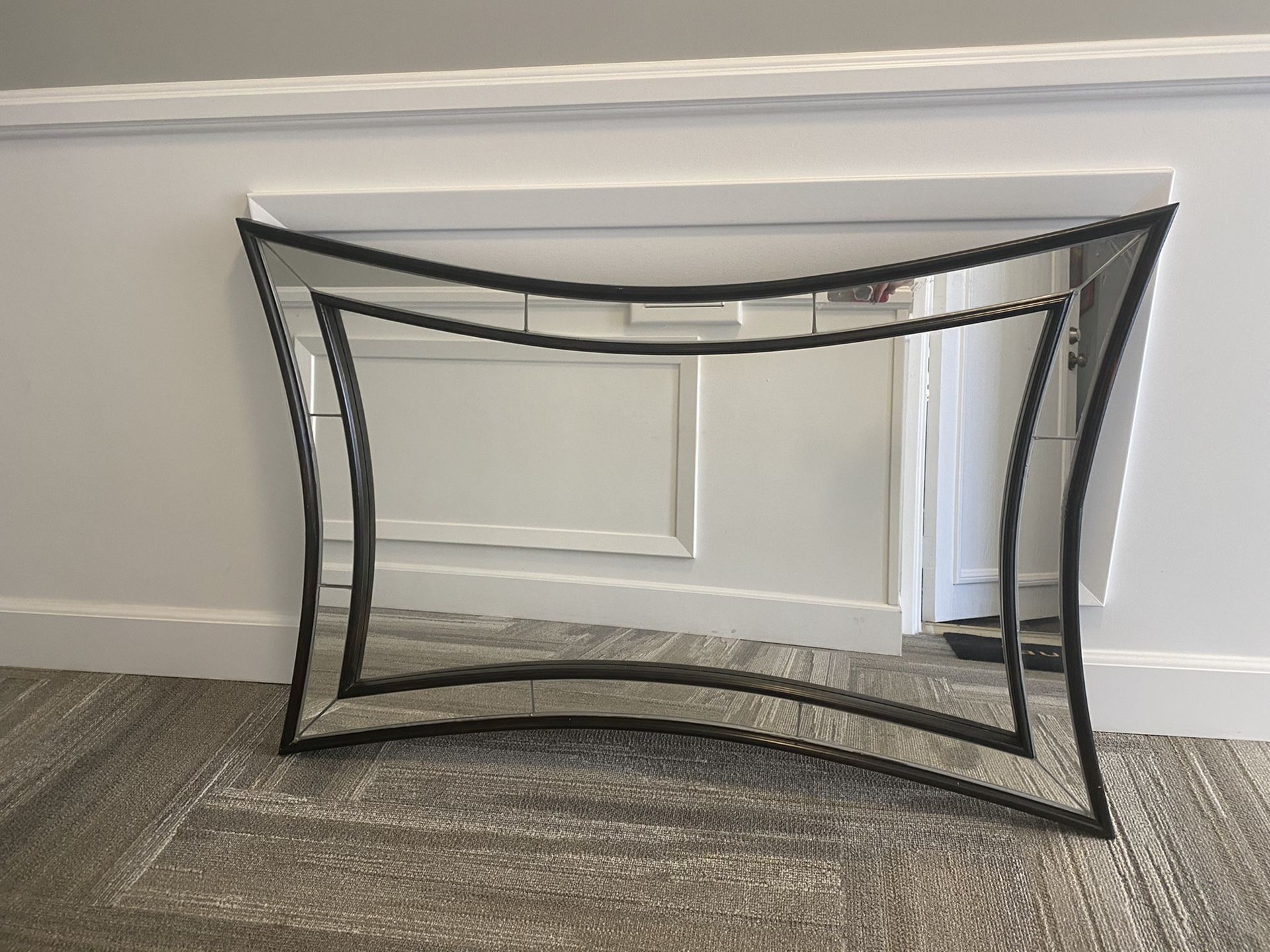 Arched wall mirror with black wood framing