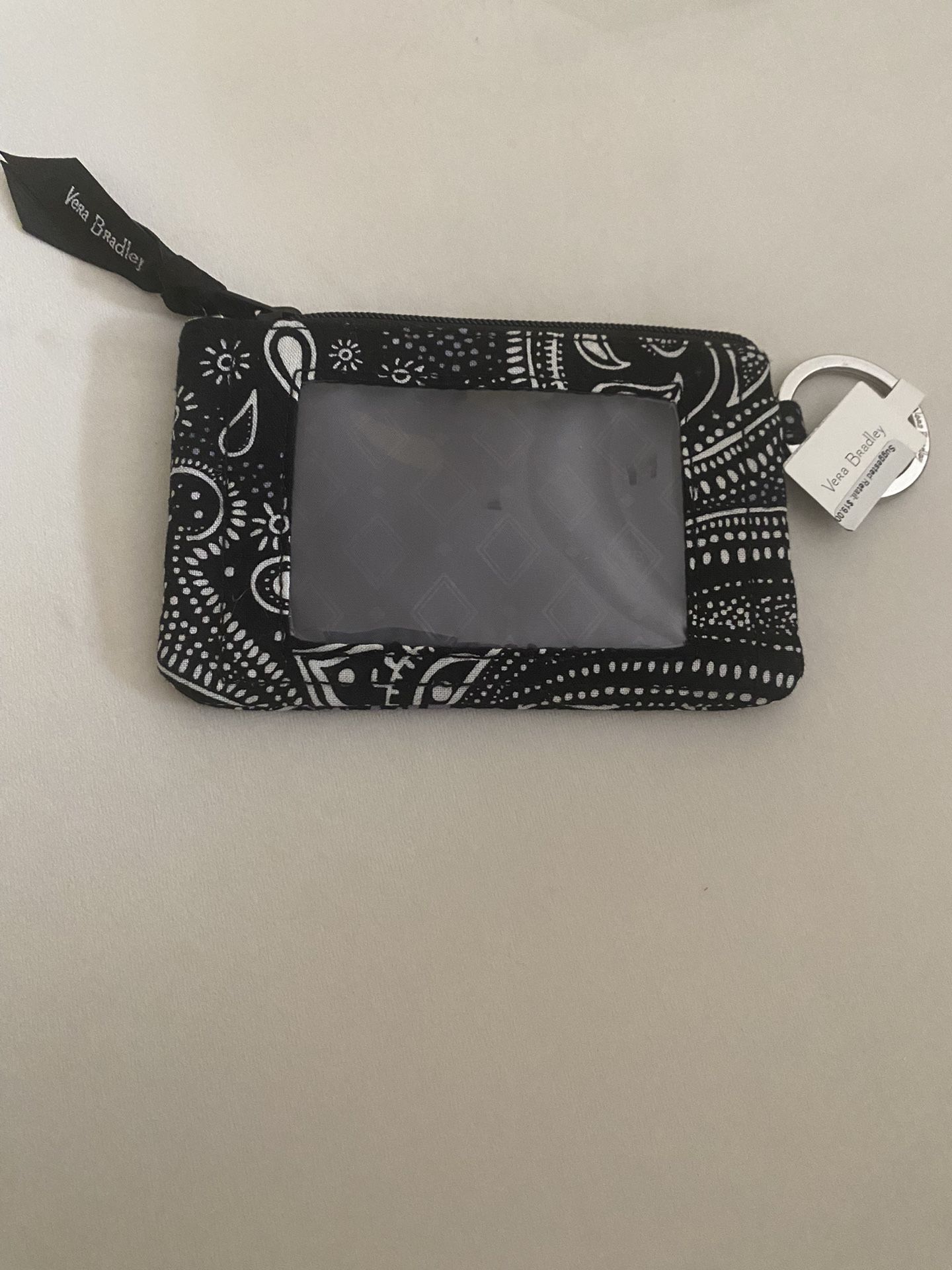 A Small Black Wallet With White Designs