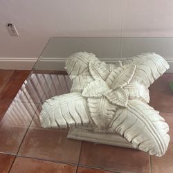 Glass table with palm leaf base