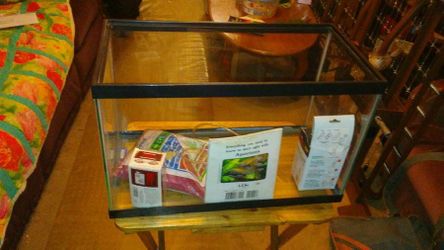 Fish tank, black strim Ming and clear, comes with gravels, filter, pump.