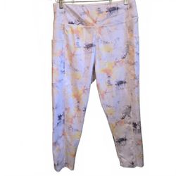 Women's activewear leggings featuring a colorful tie-dye pattern in shades of ye