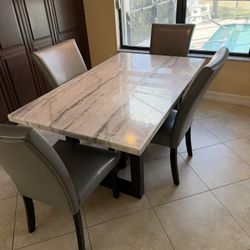 White Marble Table with Leather Chairs
