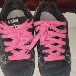 Vans Old Skool sneakers featuring a black and white butterfly pattern on the canvas side panels, accented by the signature white side-stripe and brigh