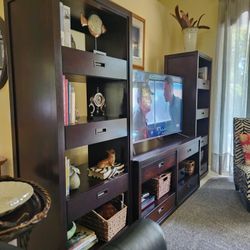 Shelving Unit For Living Room. Brown Wood Finish.  $80 For Each Side Units. $75 For Center Unit.