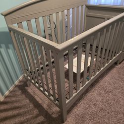 Baby crib with changing table