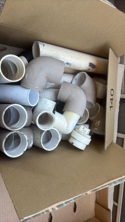 Unused PVC fittings and multiple size pipes half inch, three-quarter, inch and a half, 2 inch, 3 inch, pipe