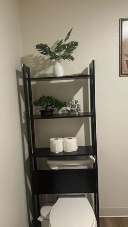 Black Over-the-Toilet Ladder Shelf. With decorative vases.