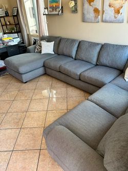 Large Grey sectional couch from Jerome’s. Cushions have memory foam. Delivery available 🚚