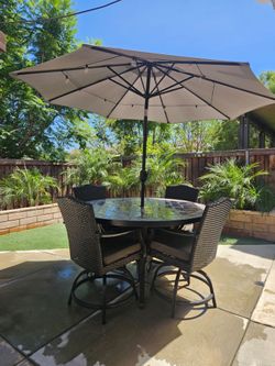 Outdoor Patio table, chairs and umbrella. Very heavy duty. Holds up in wind. $600