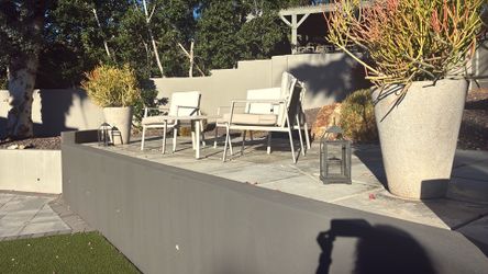 Small outdoor patio loveseat, coffee table, and two chairs