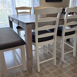 Bar height table with 4 chairs and bench