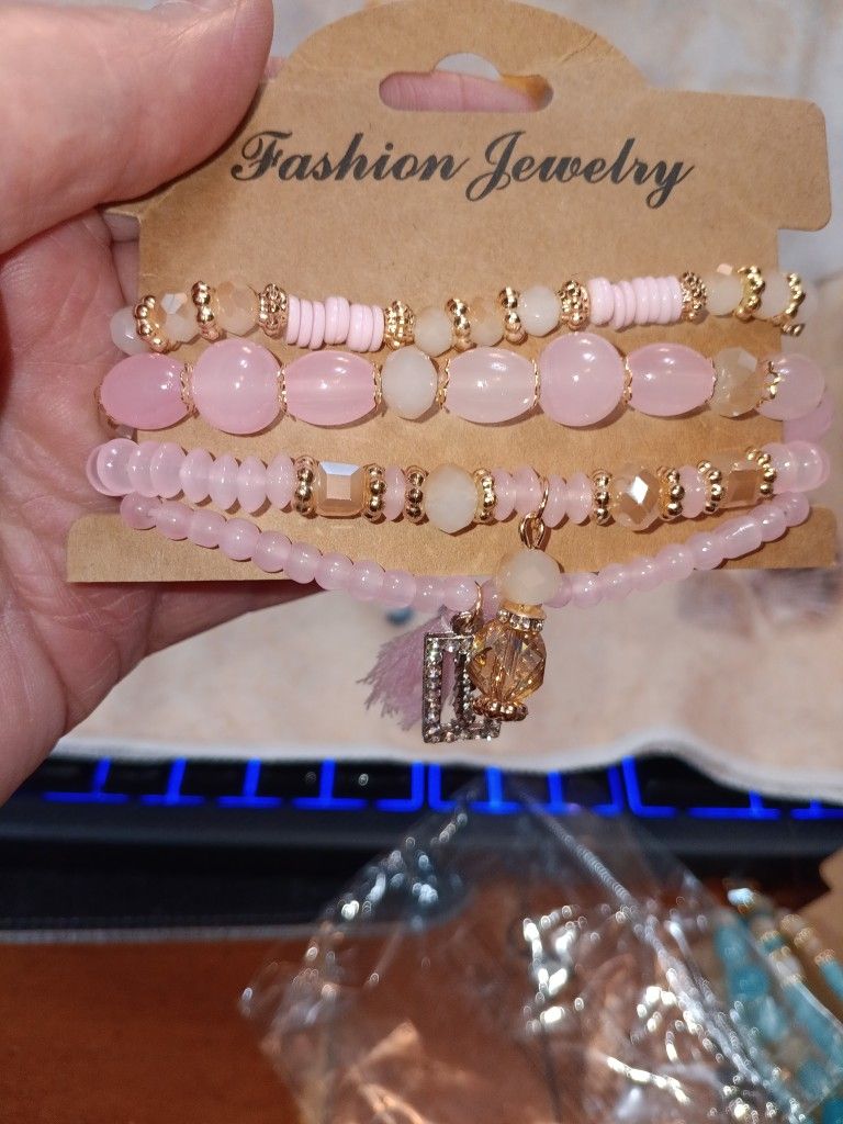 Pink Beaded Stretch Bracelets With Carm And Tassle