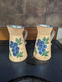 Hand painted pair of vintage metal pitchers