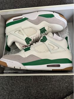 Nike SB × Air Jordan 4 "Pine Green" sneakers, featuring a white leather upper, gray suede overlays, and green accents.