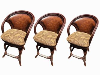 Elevate your home bar with this set of 3 premium Hooker Furniture leather & rattan swivel barstools!