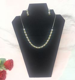 alternating yellow and white cubic zirconia stones, styled similarly to a bridal or party wear set. 