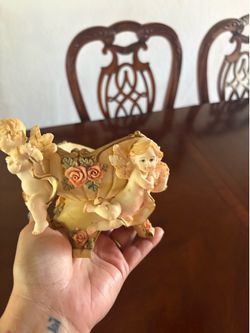 decorative bowl is identified as a jardinière or centerpiece featuring cherubs
