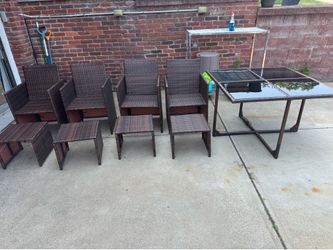 Wicker Outdoor Set Table with black glass inserts, 4 chairs and 4 ottomans, lightweight and easy to move around Table  43 1/4” wide  431/4 “ deep  28 