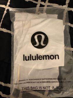 Lululemon jacket in his shorts, white and gold