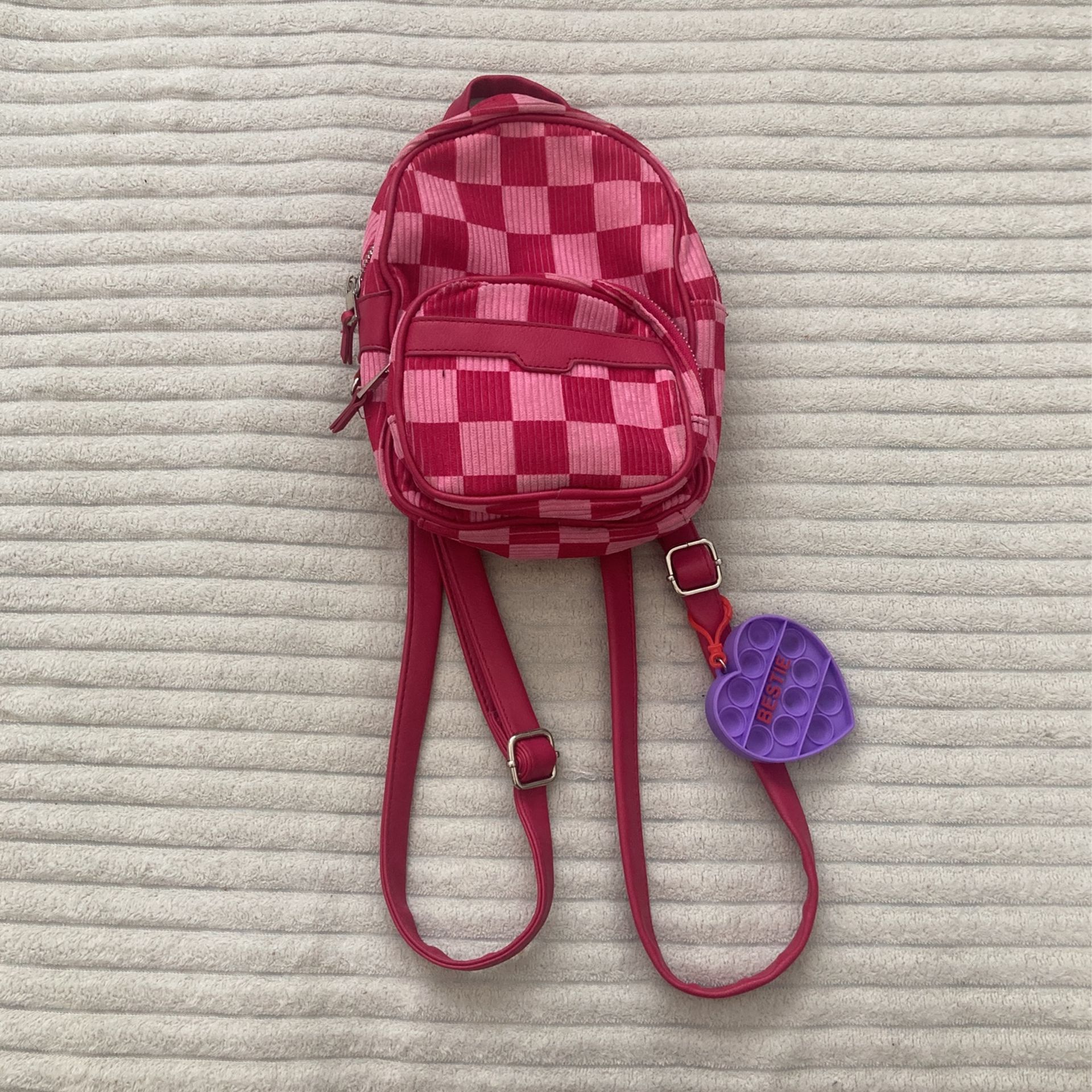 Mini magenta and pink backpack with pop it charm