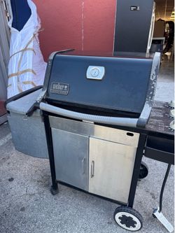 Weber Genesis Silver grill features a black porcelain-enameled hood and stainless steel doors