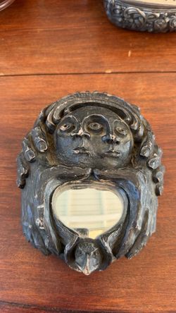 Dark Carved Face Sculpture with Mirror