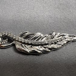 Silver Necklace With Silver Feather Pendant That Has White Cubic Zirconias 