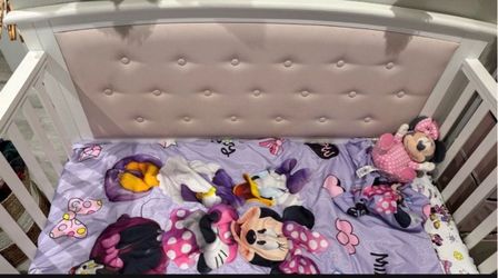 Pink crib with mattress