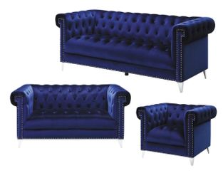 Stylish blue sofas, accompanied by three stylish coffee tables.