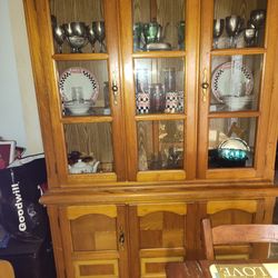 China hutch full of silver and coca cola collector items
