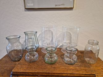 Assorted glass vases and jars, perfect for home decor. 8 pieces