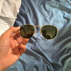 Ray-Ban RB3548N Hexagonal Flat Lenses sunglasses with a gold metal frame and green G-15 crystal lenses. 